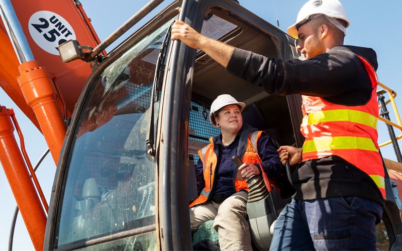 Male chatting with a female digger controller